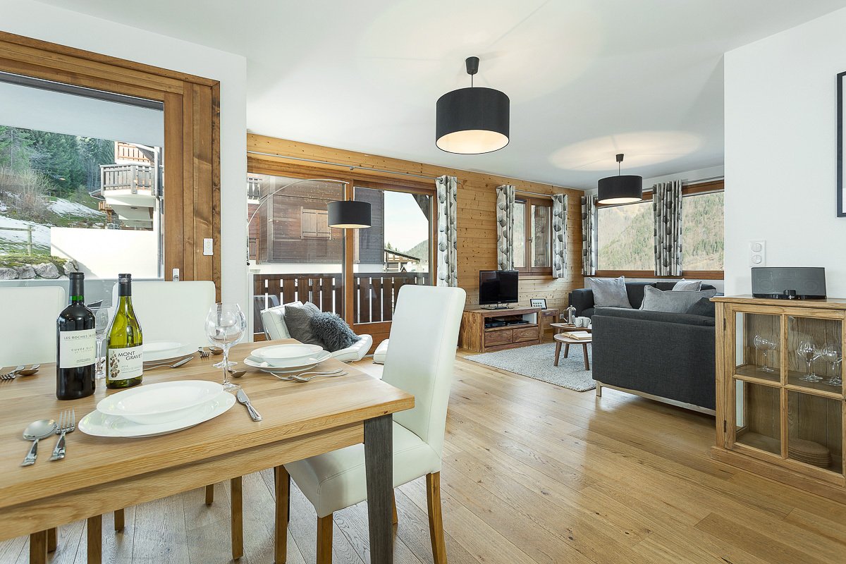 A bottle of wine sits on a table in a living room