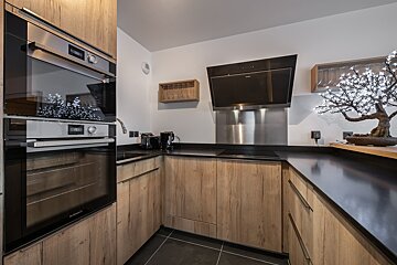 A kitchen with wooden cabinets and stainless steel appliances