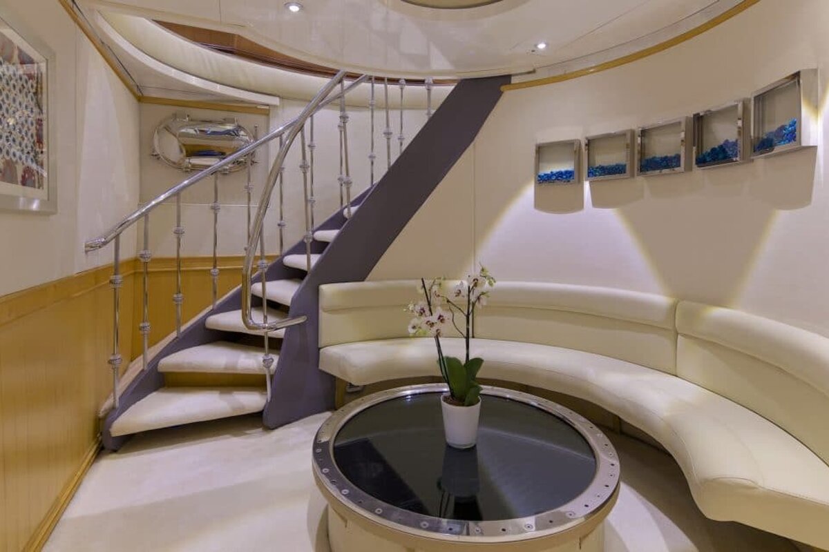 A living room with a staircase and a round table