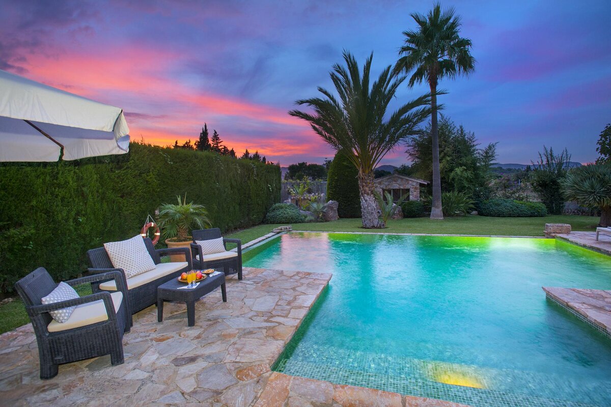 A swimming pool with a sunset in the background