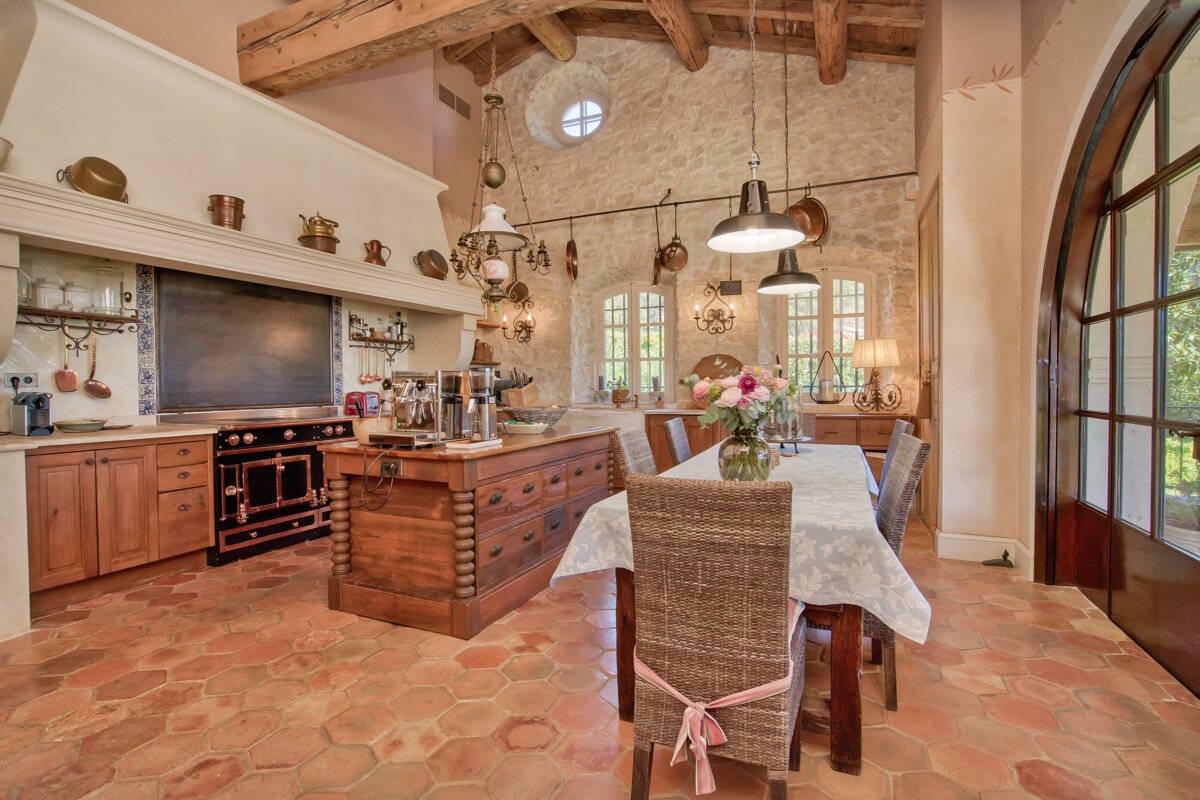 A kitchen with a table and chairs in it