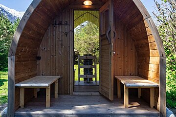 A wooden cabin with a ladder hanging on the wall