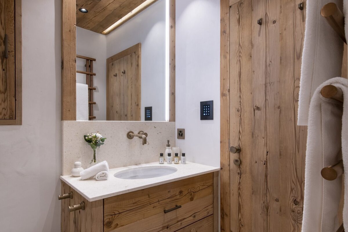 A bathroom with wooden cabinets and a sink
