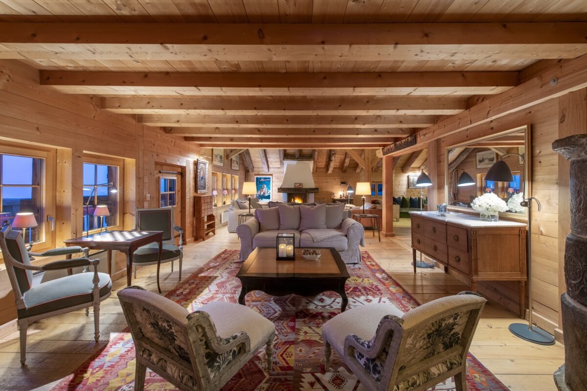 A living room with a couch and chairs and a fireplace