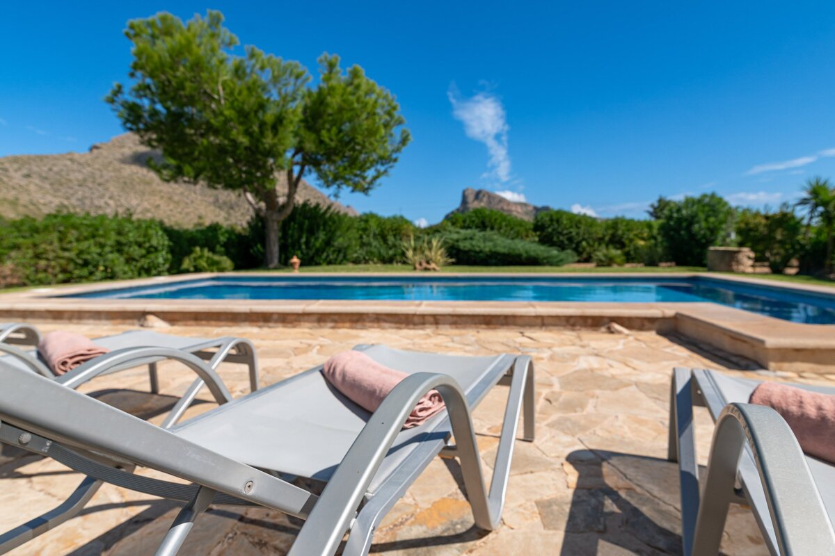 A swimming pool with a mountain in the background