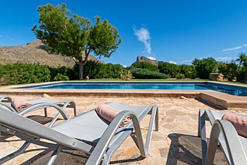 A swimming pool with a mountain in the background