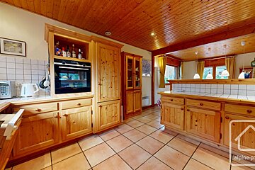 A kitchen with wooden cabinets and a sign that says alpine-pro