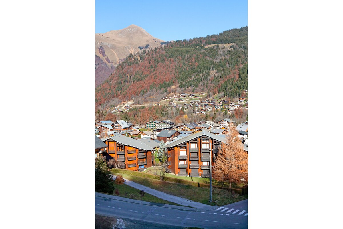 A view of a mountain village with a few buildings in the foreground