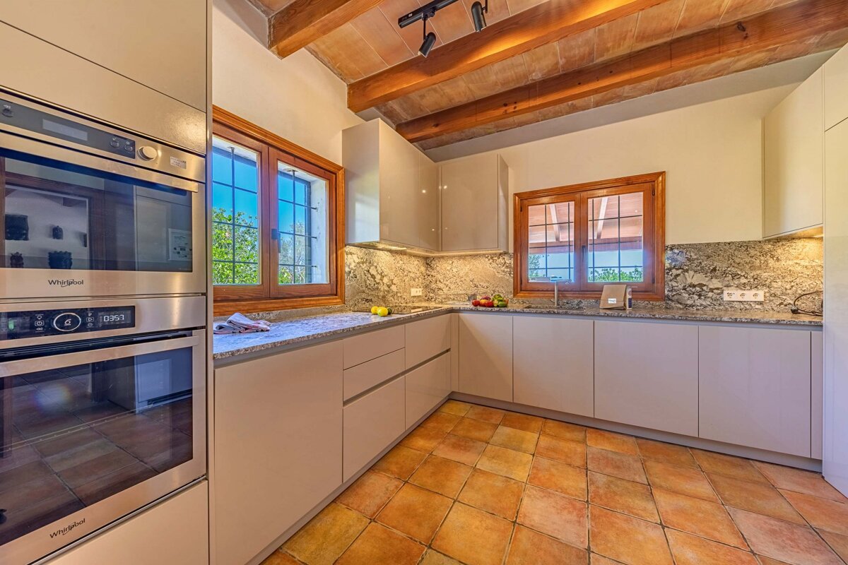 A kitchen with a whirlpool oven and a microwave