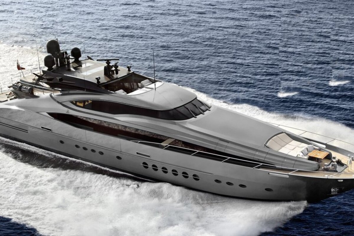 A large gray yacht is floating in the ocean
