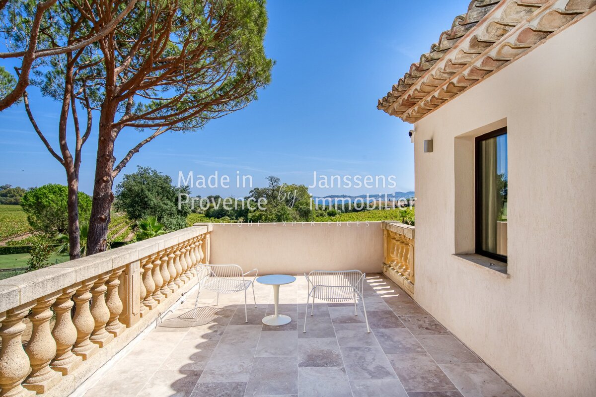 A balcony with a table and chairs and the words made in provence