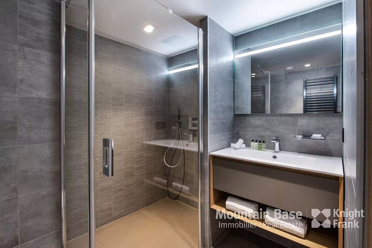 A bathroom with a knight frank logo on the wall