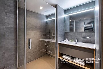 A bathroom with a knight frank logo on the wall