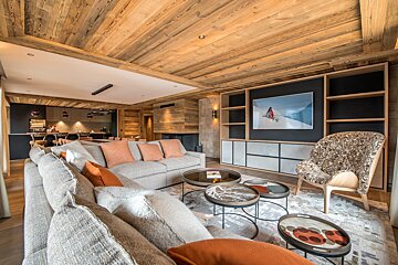 A living room with a couch a chair and a television