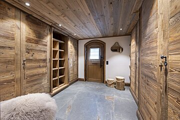 A hallway with wooden cabinets and a door