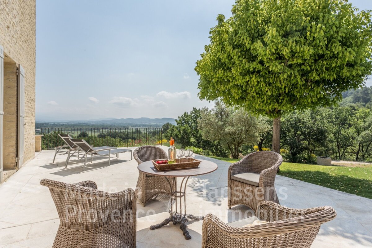 A patio with chairs and a table that says provence on it