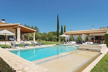 A large swimming pool is surrounded by chairs and umbrellas
