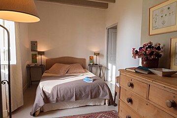 A bedroom with a small bed and a dresser