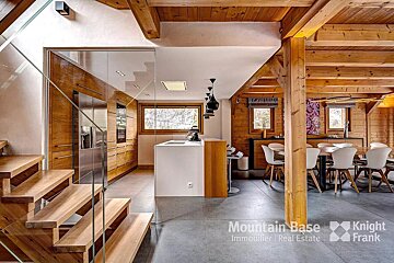 A kitchen and dining room with a sign that says mountain base immobilier real estate
