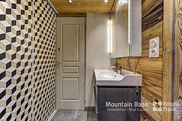 A bathroom with a knight frank logo on the wall