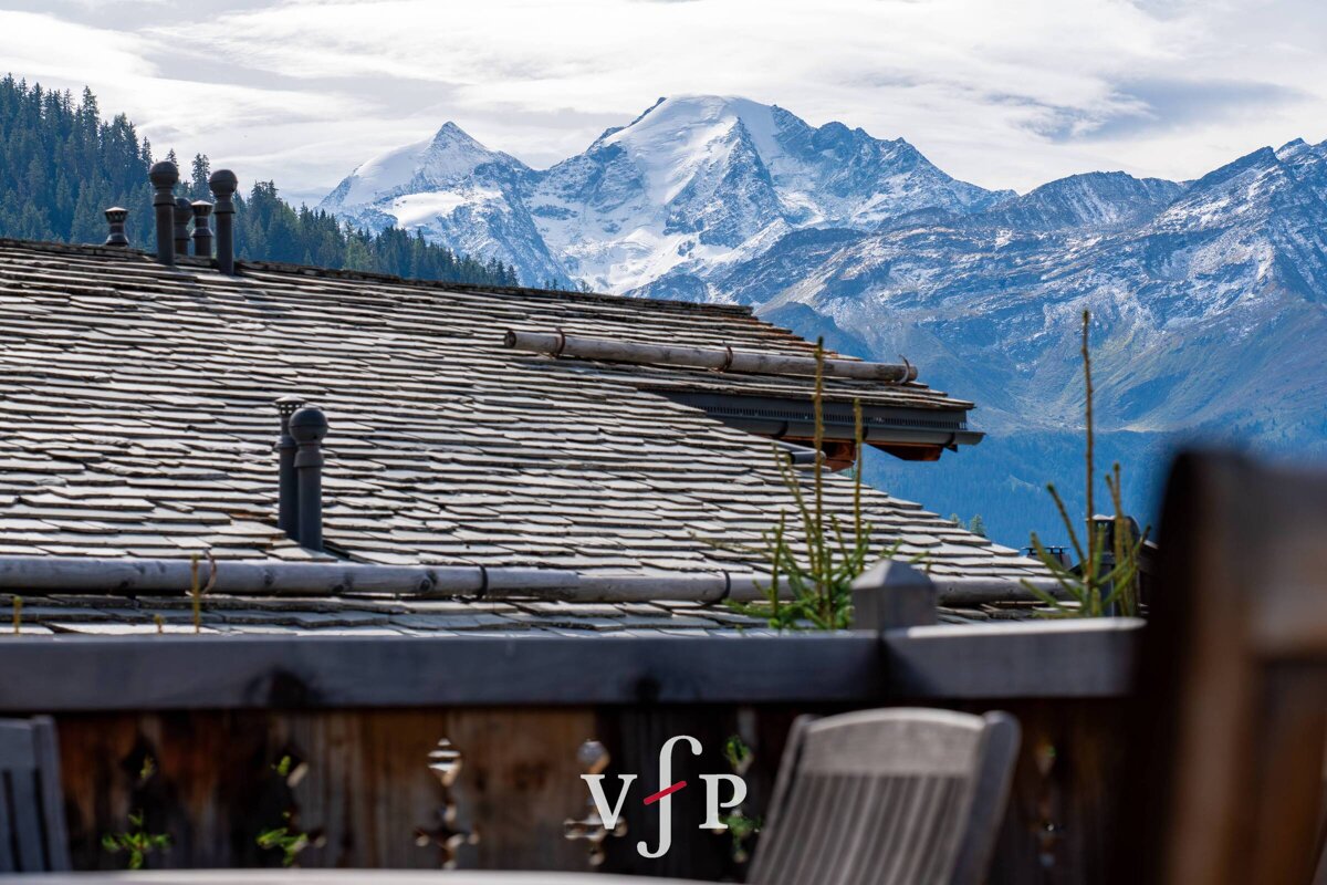 A view of the mountains from a balcony with the letters vfp on it