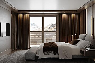 A bedroom with a large bed and a large window