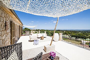 A balcony with a white umbrella over it