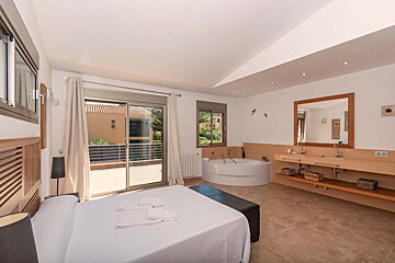 A bedroom with a bathtub and a sink with a box that says ' french ' on it