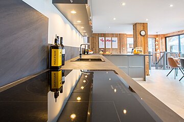 A kitchen with a bottle of huile d' olive on the counter