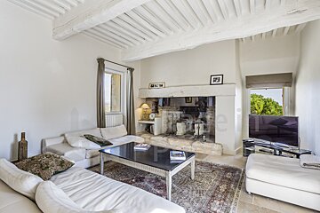 A living room with a fireplace and a white couch