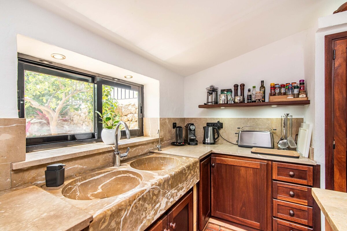 A kitchen with two sinks and a toaster