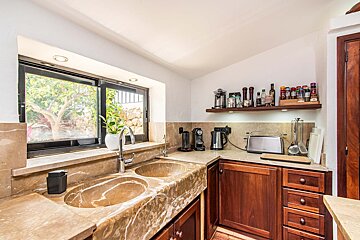 A kitchen with two sinks and a toaster