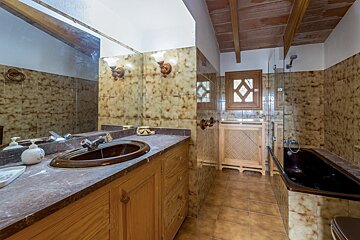 A bathroom with a sink a mirror and a bathtub