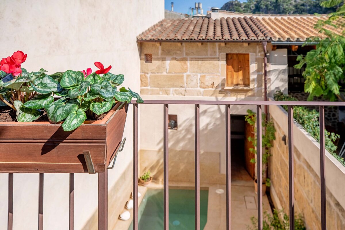 A balcony with a planter of flowers on it