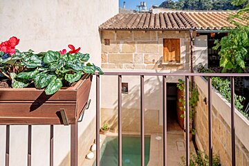 A balcony with a planter of flowers on it