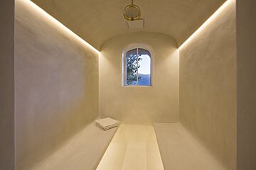A narrow room with a window in the corner