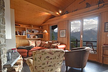 A living room with a couch a chair and a fireplace