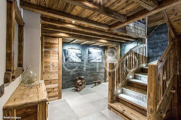 A wooden staircase leading up to the second floor of a house