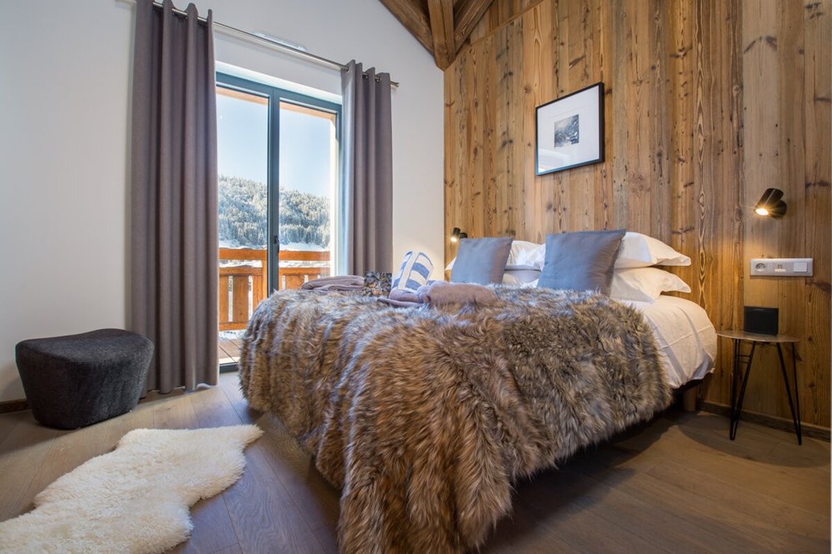 A bedroom with a fur blanket on the bed