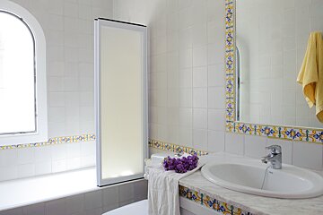A bathroom with a sink a toilet and a window