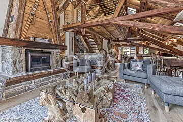 A living room with a fireplace and a glass coffee table