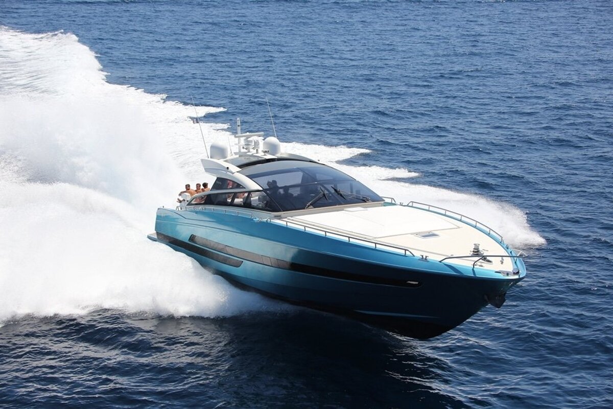 A blue and white boat is going through the ocean