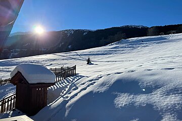 A snowy landscape with mountains in the background
