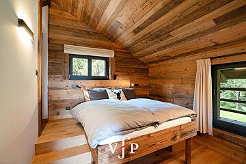 A bedroom with wooden walls and a bed that says vip on it
