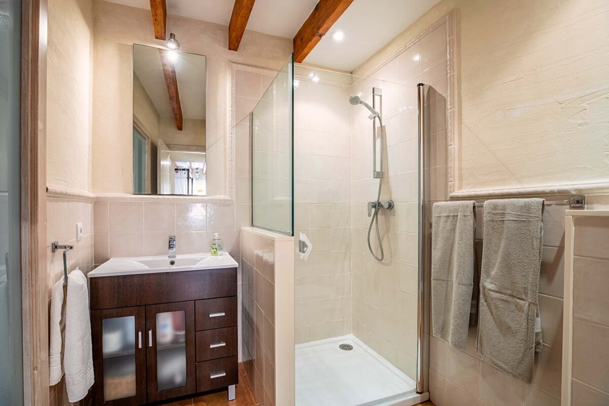 A bathroom with a sink and a walk in shower
