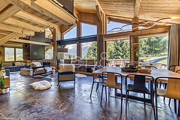 A living room with a dining table and chairs