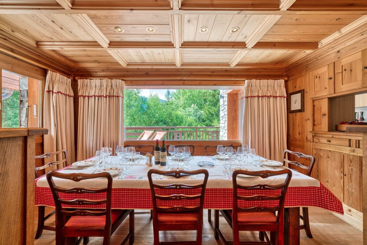 A dining room table with a red and white checkered table cloth