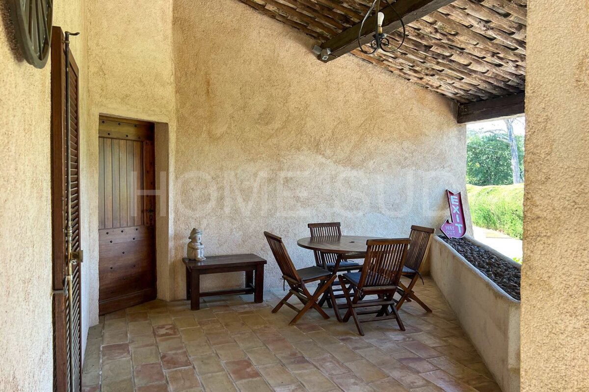 A patio with a table and chairs and a sign that says home sur