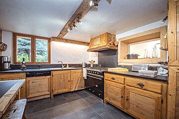 A kitchen with wooden cabinets and a stove top oven