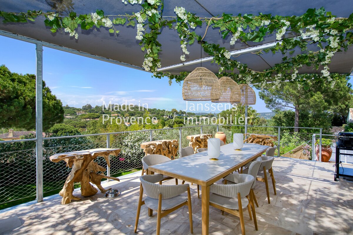 A balcony with a table and chairs and a sign that says made in provence